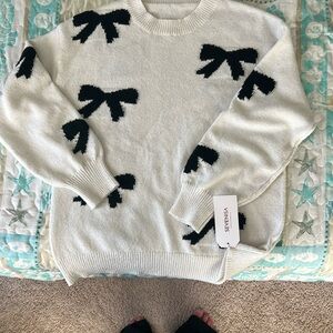 Sevenisa off white sweater with black bows. Size small. New with tags. Fits big
